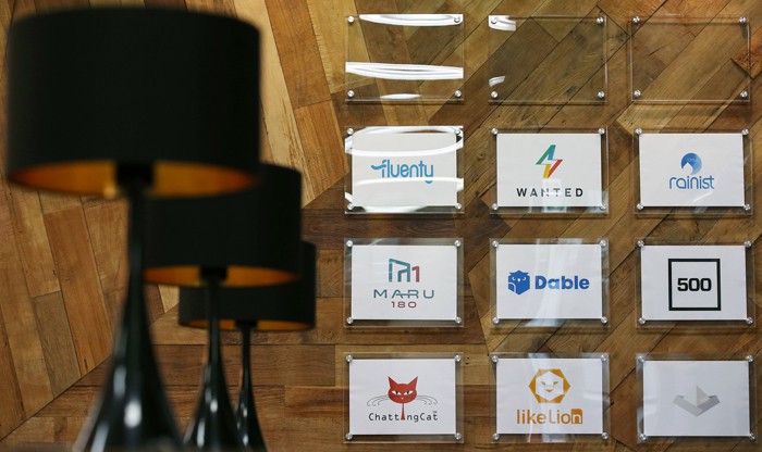  Logos for startup companies and partners at Camus Seoul are displayed on the wall.