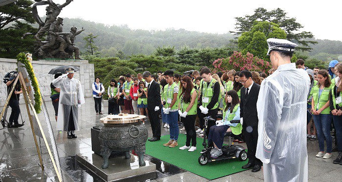 Participants in the Youth Peace Camp pay silent tribute at the Seoul National Cemetery on July 24.