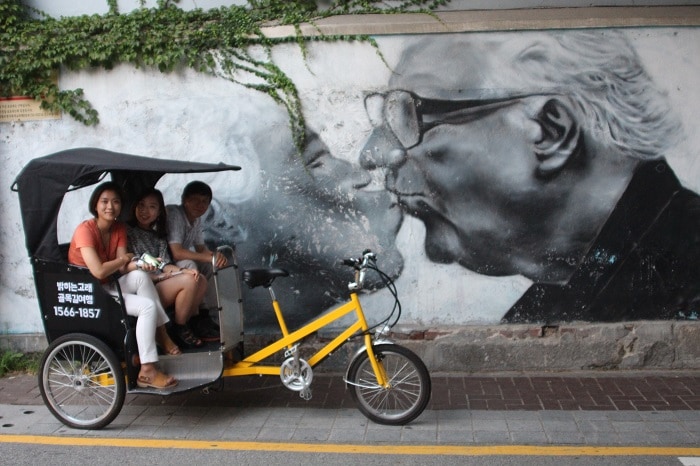 Jun, a pedal bike driver, introduces travelers to the history and hidden spots of Bukchon.