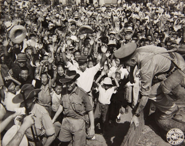  Seoul citizens cheer as Allied Forces march through Seoul in September 1945.