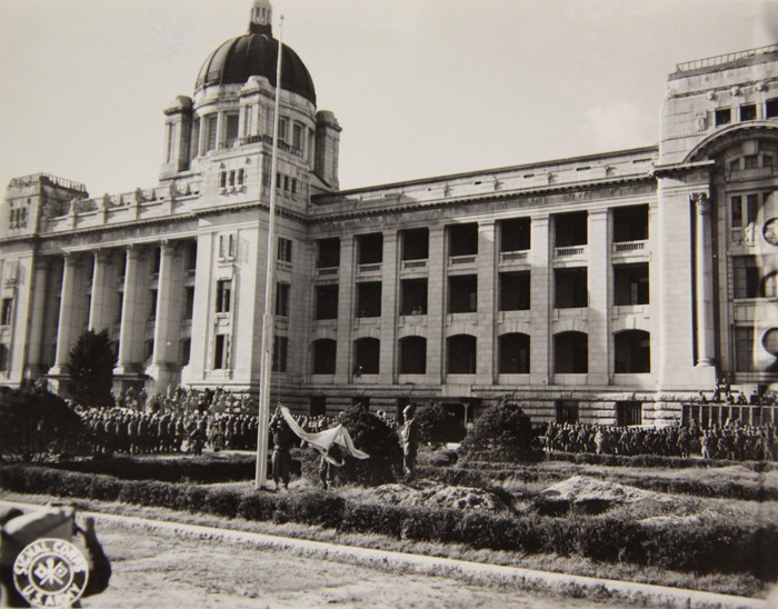  The Japanese flag is lowered in front of the colonial government building on Sept. 9, 1945.