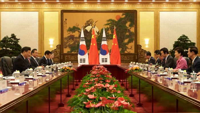 President Park Geun-hye and Chinese President Xi Jinping discuss measures to further develop their bilateral relationship during a summit meeting in Beijing on Sept. 2.