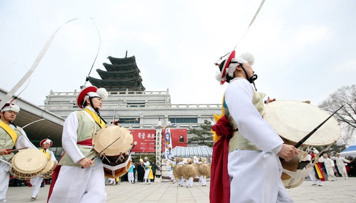 A <i>pungmul</i> percussion dance is held in front of the National Folk Museum of Korea.