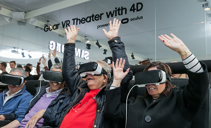 22일 스페인 바로셀로나에서 열리고 있는 MWC 삼성전자 ‘Gear VR Theater with 4D’ 부스를 찾은 관람객들이 가상체험을 하며 즐거워하고 있다. (삼성 뉴스룸 플리커 채널)