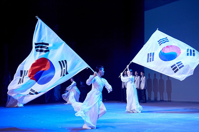 Performers wave the Taegeukgi, the national flag, during the March First Independence Movement Day commemoration ceremony on March 1 in Seoul.