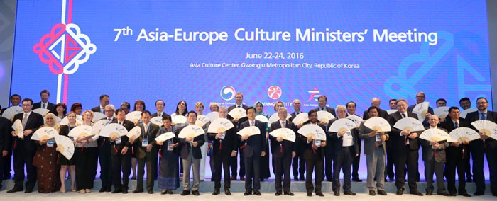 Participants in the seventh Asia-Europe Culture Ministers' Meeting pose for a group photo on June 23 in Gwangju, holding traditional Korean fans that read 'Culture and the Creative Economy' in Korean.