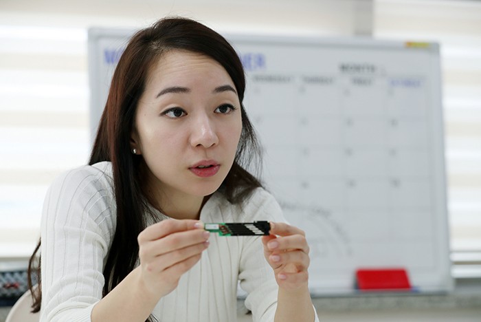 PR marketing manager at Dot Choi Ah Rum holds up a core 'part cell' of the braille equipment that's used by many people with a visual impairment. Dot developed a mini braille cell, one 20th the size of the original. Dot’s cell is also considerably cheaper than standard braille equipment.