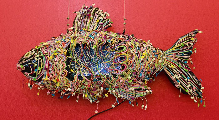 Waste collected from the Gwangmyeong Resource Recovery Facility and the Gwangmyeong Cave was provided to artists that work and reside at the Gwangmyeong Upcycle Art Center (top). They transform the recycled material into works of art. Artist Cheon Geun Seong created a colorful fish using discarded phone chargers (bottom).