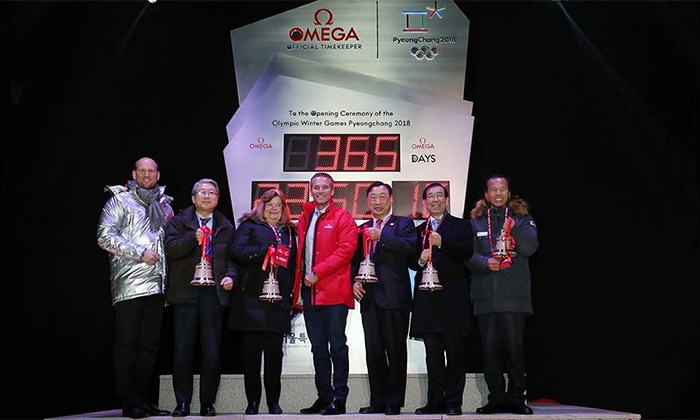 Participants celebrate the start of a countdown clock for the PyeongChang 2018 Olympic Games in front of Seoul City Hall on Feb. 8