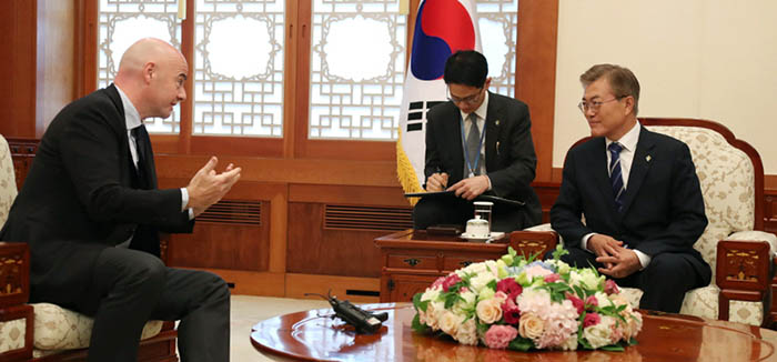 FIFA President Gianni Infantino (left) is greeted by President Moon Jae-in at Cheong Wa Dae on June 12.