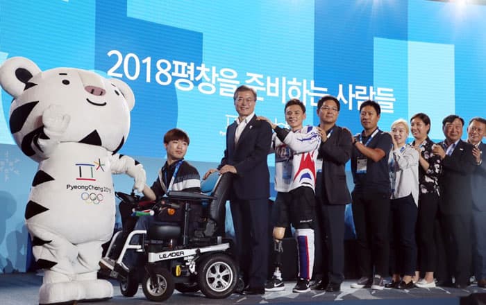 President Moon Jae-in poses for a photo with athletes and members of the organizing committee during a special event to promote the PyeongChang 2018 Olympic and Paralympic Winter Games, at Alpensia Resort in Pyeongchang on July 24.