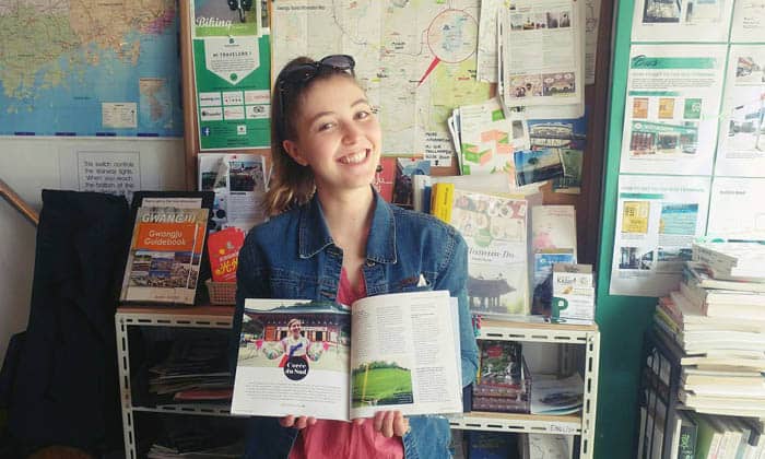 Lea Moreau began living in Korea when she settled in Gwangju, Jeollanam-do Province. Here, Moreau poses for a photo with the English edition of the travel guide she wrote for the province in 2016.