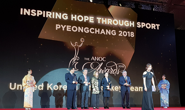 South Korean player Park Jong-ah (front) and North Korean player Kim Un-hyang (fifth from the left, behind), members of the PyeongChang 2018 Olympic Ice Hockey Team, are being awarded at the ANOC Awards, in the Tokyo Prince Hotel on Nov. 28. Korean Sport & Olympic Committee