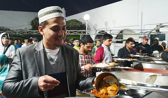 Bangladeshi national Shumon Sheikh on May 8 fills his plate with his daily iftar (dinner) at Seoul Central Mosque in the capital’s Itaewon neighborhood.