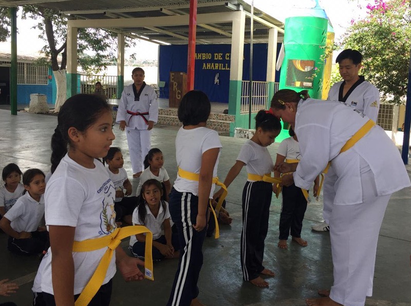 Taekwondo students on Aug. 7 receive yellow belts at a public elementary school (Centro Escolar Básico Gubernamental Guatemala) in the Honduran capital of Tegucigalpa. (Honorary Reporter Luis Hércules)
