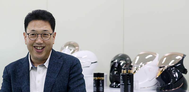 Cellreturn CEO Kim Il-soo poses with his company's innovative LED masks at his office in Incheon.