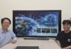 A research team at the Korea Advanced Institute of Science and Technology (KAIST) has developed GeoCore-9B, an artificial intelligence model for the generation, restoration and transformation of satellite imagery. Shown are professor Kim Munchurl (left) from KAIST's School of Electrical Engineering and the study's lead author Do Jeonghyeok sitting in front of a large screen displaying their team's achievements.